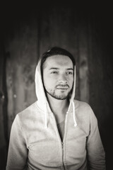 Young man in front of wooden wall