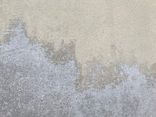 Black mold and yellow stain on old yellow cracked cement wall. Wall cracks that cause mold on the paint.