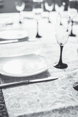 Table served for guests. Selective focus. Shallow depth of field. Black and white image.