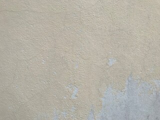 Black mold and yellow stain on old yellow cracked cement wall. Wall cracks that cause mold on the paint.