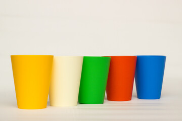 multi-colored plastic glasses on a white background