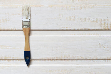 Horizontal boards painted with white paint and a brush. Selective focus. Repair and design. Space...