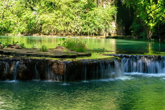 Waterfall in deep tropical rain forest green tree © themorningglory