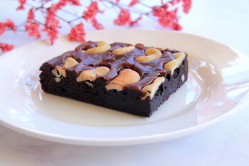 Delicious brownies on white cup for breaking fasting, flower Component and Marble floor.