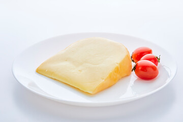 gouda cheese with tomatoes on white