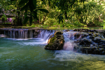 Waterfall in deep tropical rain forest green tree