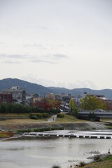 Fototapeta na wymiar Stone path and bridge crossing Kamo River in Kyoto