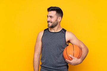 Obraz premium Handsome young basketball player man over isolated white wall looking side