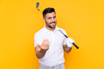 Golfer player man over isolated yellow background inviting to come with hand. Happy that you came