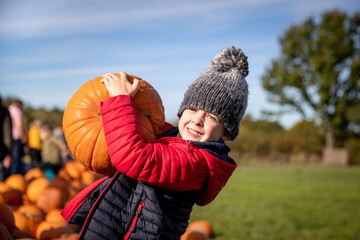 Boy selecting the perfect pumpkin