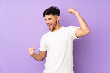 Arabian handsome man over isolated background celebrating a victory