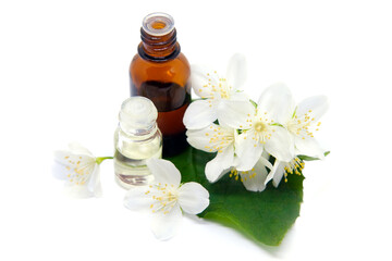 Essential aroma oil with jasmine on white background.