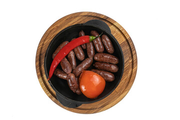 hunting sausages baked in a pan on a wooden board on a white background
