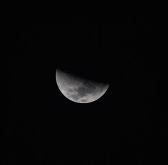 Half moon in front of a black sky