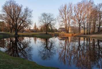 Fototapeta na wymiar Trees reflecting in the pond of the garden in National Botanic Garden, Salaspils, Latvia 
