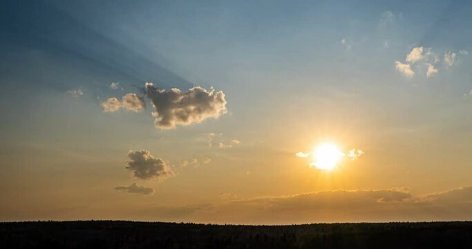 Beautiful evening sunset, time lapse, movement of clouds of a different level against the setting sun