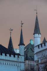 View to the roofs and towers of the Small Guild and the Great Guild in the Old Town of Riga under dramatic evening clouds