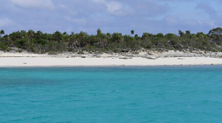 A stunningly white sandy beachline gives perfect contrast to the blue waters of the Exuma Cays in the Bahamas.