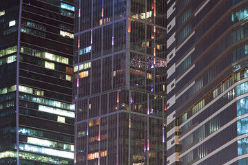 Fototapeta na wymiar Close up of modern skyscraper illuminated at night
