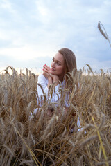 Portait of a woman outdoors, selective focus. Woman On Wheat Field