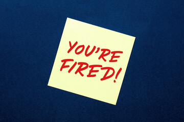 You are fired note written on sticky paper attached to a bulletin board