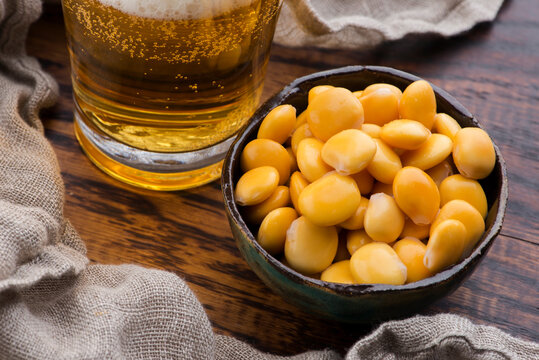 Tasty lupins and glass of beer. Beverage, legume.