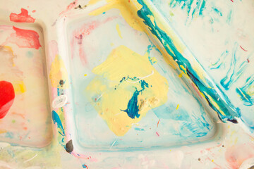 Mixing paints, close-up. Abstract colorful background, wallpaper with artist's palette