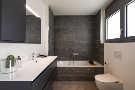 Interior of an empty and luxurious modern bathroom, nobody inside. It is a private home