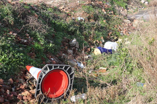 Fly tipping waste by roadside in British countryside