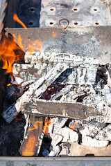 Burning firewood for bbq grill grate