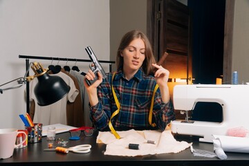 The dressmaker's girl looks at the sketch with disdain. A young seamstress holds a gun and a cigar