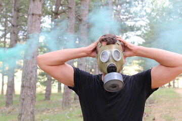 Man wearing rubber mask in toxic environment 