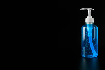 Covid-19 concept. Blue alcohol gel isolated on black background with copy space. Hand sanitizer gel for clean. Hand sanitizer in pump head bottle.