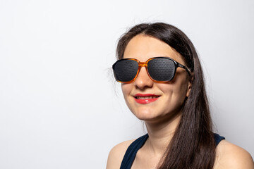 
Girl and perforating glasses exercise machines. Glasses for relaxing the eye muscles and improving...