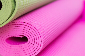 Green and pink yoga mats. Equipment for sport. Healthy lifestyle concept. Close-up, copy space