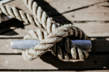 Fototapeta na wymiar Vintage old sea rope near the port, summer time