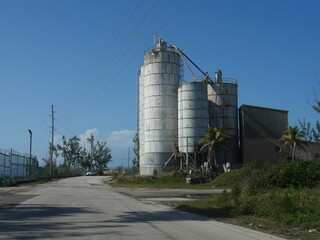 Fototapeta na wymiar Towering tanks stand by the roadside at a power plant in Nassau, Bahamas