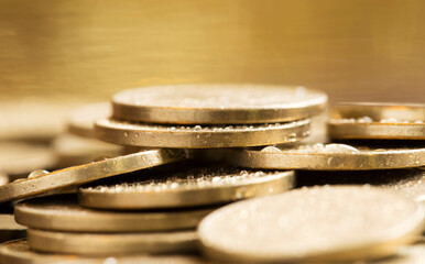 Wealth, luxury concept, shiny gold money coins closeup with copy space