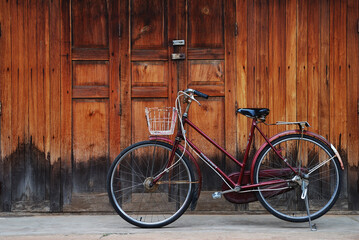 Fototapeta na wymiar Classic bicycle in front of the wooden house, Loei, Thailand.
