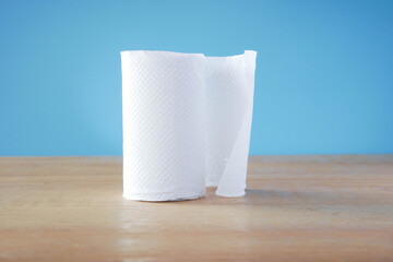 Simple toilet paper on blue background. roll of toilet paper on white background