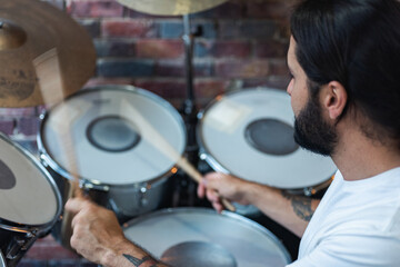 .man playing drums at home