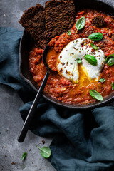 Jewish breakfast with poached egg in tomato sauce 