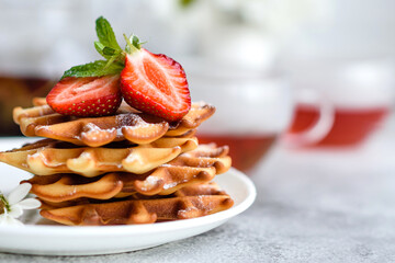 Delicious fresh baked belgian waffles with berries and fruit