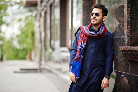 Stylish pakistani indian muslim arabic man in kurta dhoti suit and sunglasses.