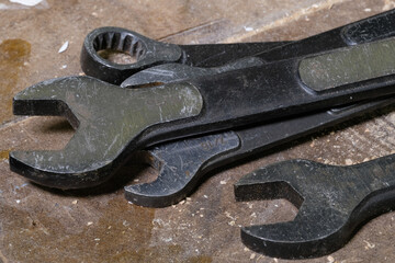 Close up of renches laying on workbench