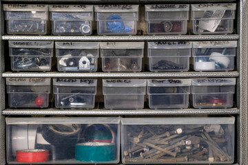 Odds and ends in storage trays on a workbench