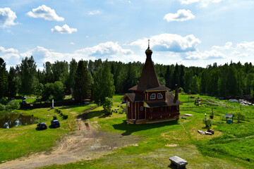 chapel with a dome and a cross in a forest glade