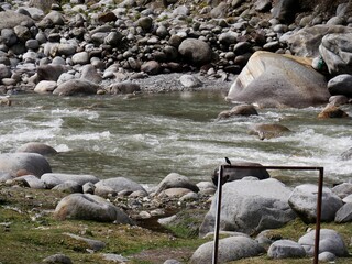 Water flows in a rocky river bed in the Himalayas