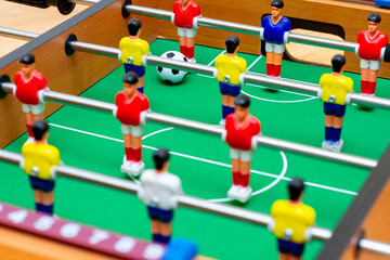 Close up table soccer with players and a ball.