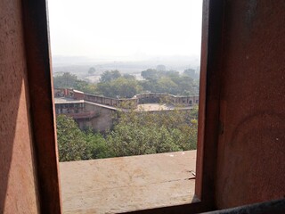 Fototapeta premium View of the outer walls of the Agra Red Fort, seen from an open window of the Jahangiri Mahal.